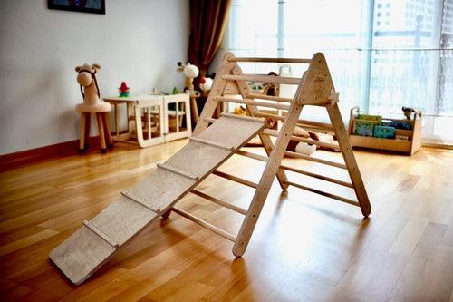 Montessori climbing set with wooden Pikler triangle and climbing ramp in a bright playroom