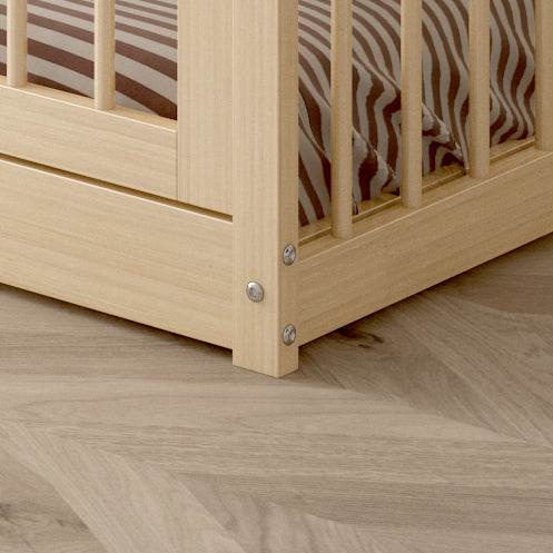 Close-up of natural pine wood frame corner with guardrails on DREAM RAFT MONTESSORI natural floor bed twin size