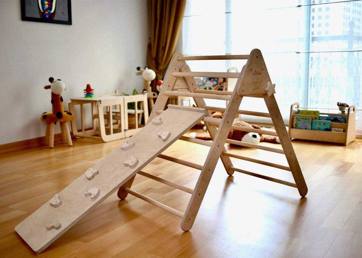 Montessori climbing set with wooden Pikler triangle and climbing ramp in a bright playroom