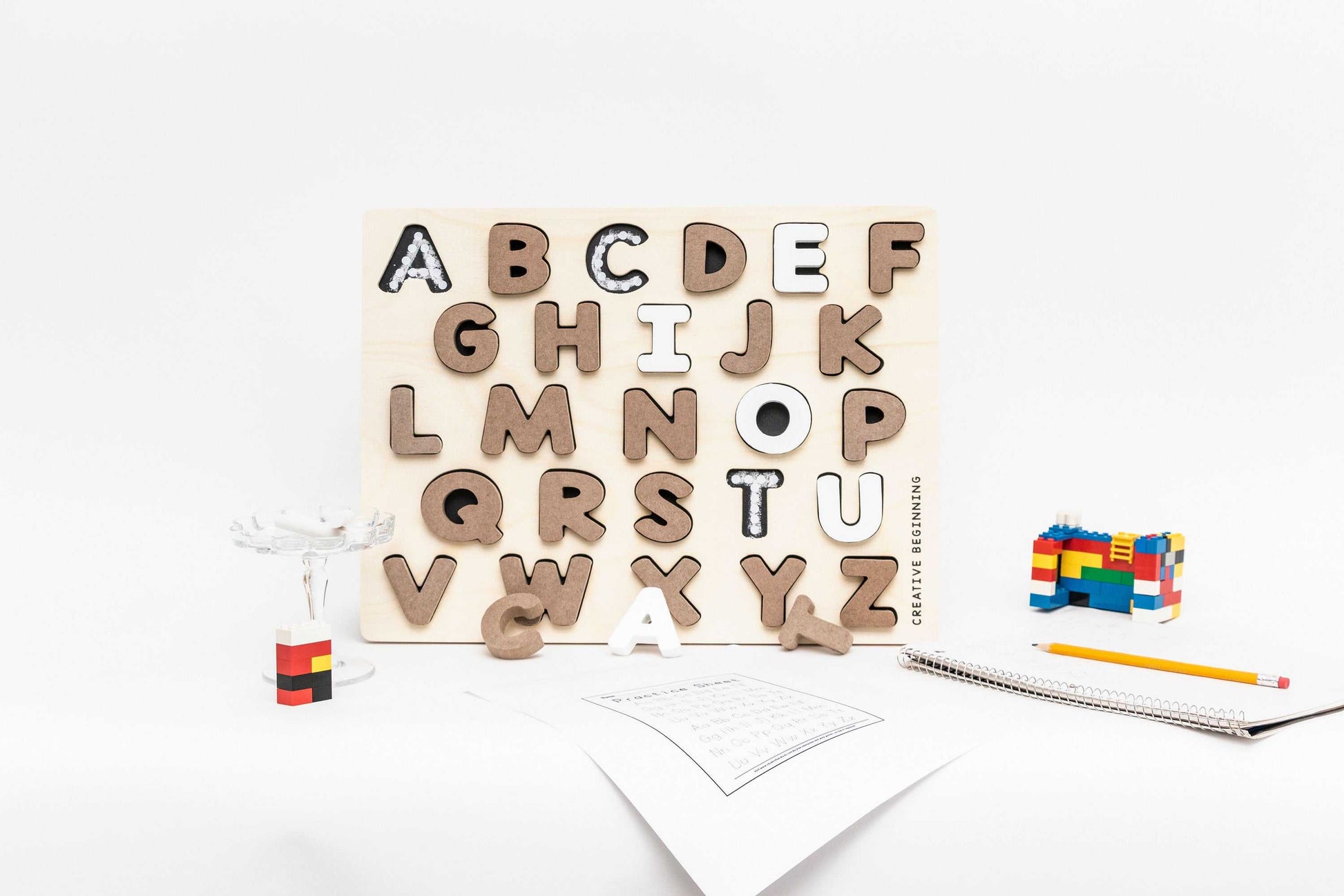 Alphabetical puzzle with chalkboard base and tracers for educational learning with neutral colors and indented letter spaces