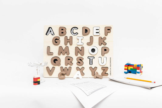 Alphabetical puzzle with chalkboard base and tracers for educational learning with neutral colors and indented letter spaces