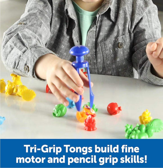 Child using Learning Resources Grab & Sort alien counters with tri-grip tongs for fine motor skill development