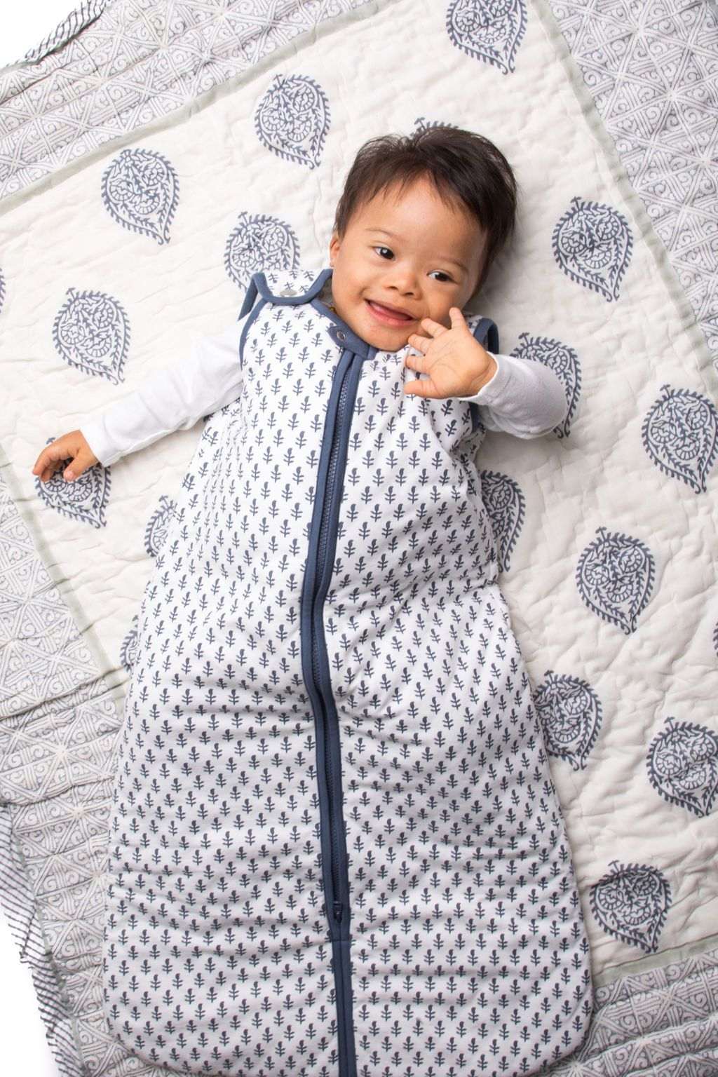 Baby wearing lightweight FORT Wearable Baby Sleep Bag made of 100% organic cotton with zipper and snap closure.